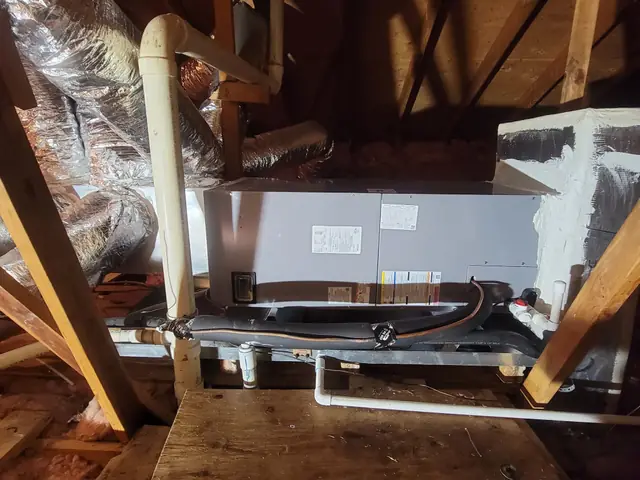 An attic air handler installed by JTech Mechanical, with insulated line set and a secondary drain pan and float switch